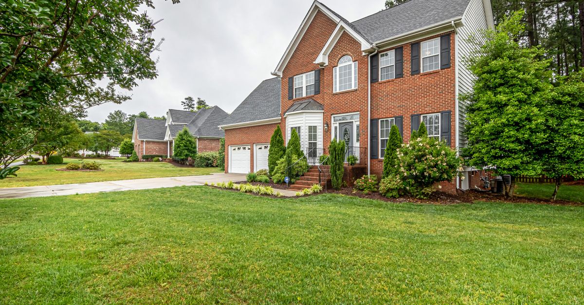 A single-family home with a manicured lawn, representing the homeowners burdened by Illinois property taxes