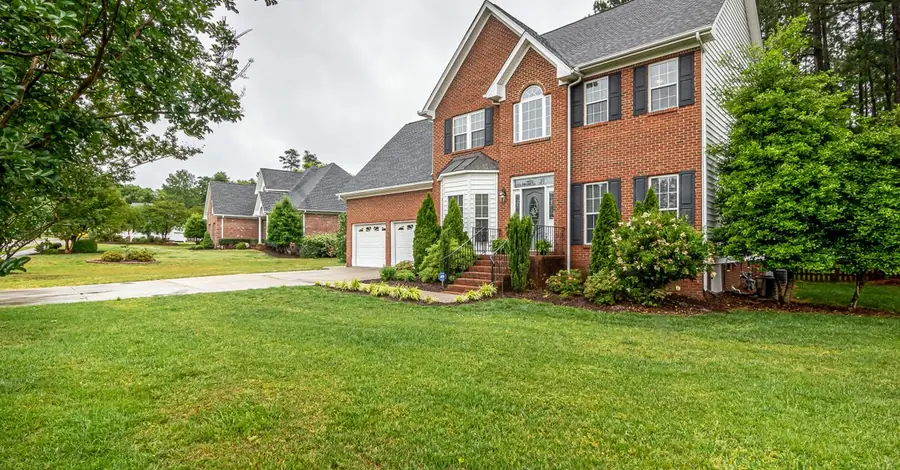 A single-family home with a manicured lawn, representing the homeowners burdened by Illinois property taxes